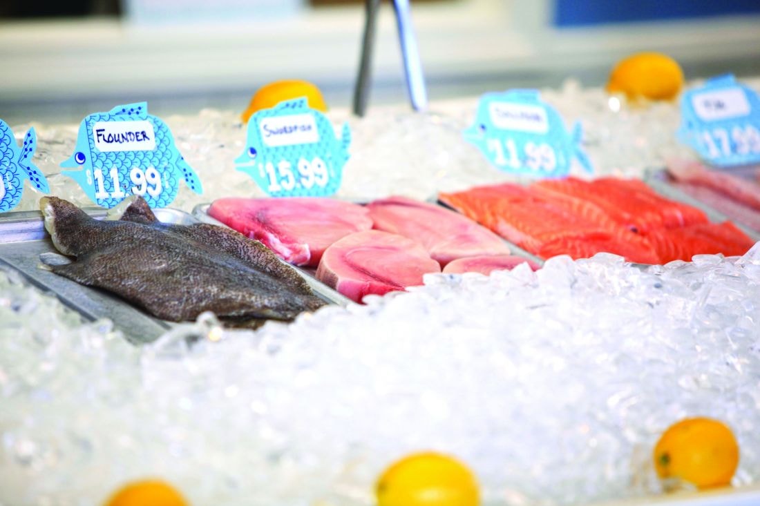 Fresh fish counter with flounder, swordfish, and salmon on ice