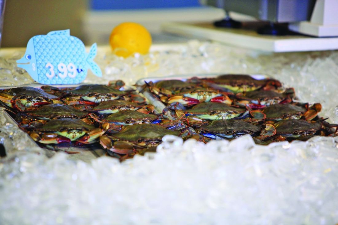 Live blue crabs on ice at the market
